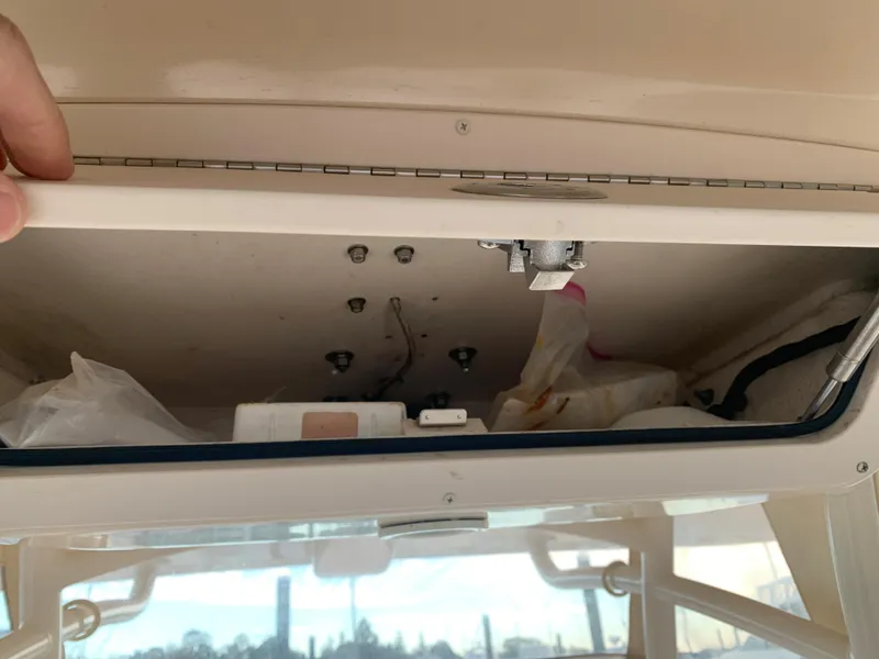 Slide: The Image of Storage compartment of 2013 Grady-White Canyon 271 boat with various items inside. - 34