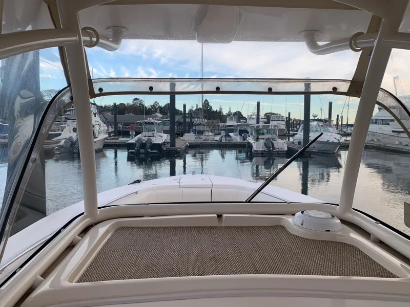 Slide: The Image of View from the helm of a 2013 Grady-White Canyon 271 at a marina. - 35