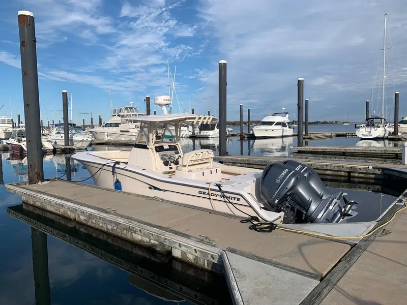 Slide: The Image of 2013 Grady-White Canyon 271 boat docked at a marina with clear skies. - 38