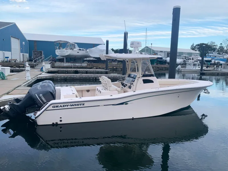 Slide: The Image of 2013 Grady-White Canyon 271 boat docked at a marina. - 4