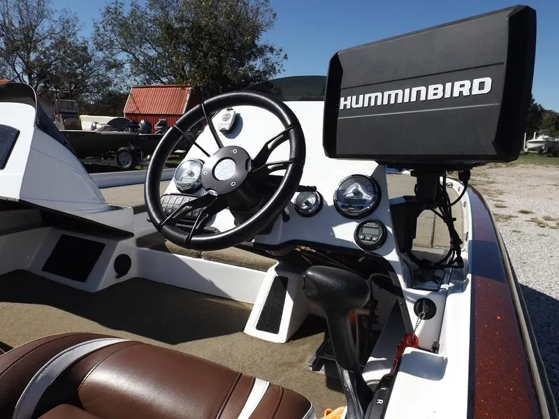 Slide: The Image of Legend V21 2017 boat dashboard with Humminbird fish finder and steering wheel. - 10