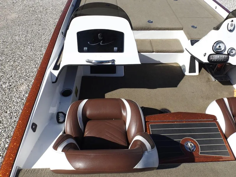 Slide: The Image of 2017 Legend V21 boat interior with brown and white seating, dashboard, and carpeted flooring. - 19