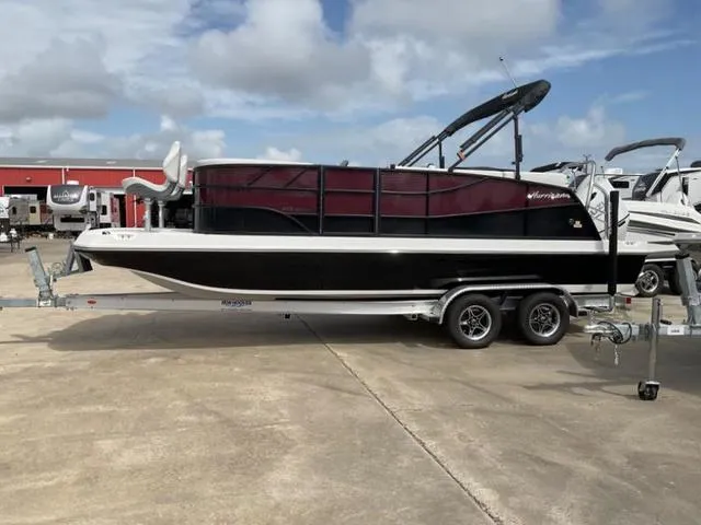 Slide: The Image of 2023 Hurricane FD2260F boat on trailer, parked outdoors under cloudy sky. - 1
