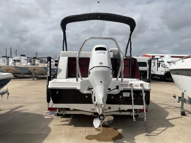 Slide: The Image of 2023 Hurricane FD2260F boat with outboard motor, docked on a cloudy day. - 4