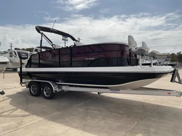 Slide: The Image of 2023 Hurricane FD2260F boat on trailer, parked outdoors under cloudy sky. - 6