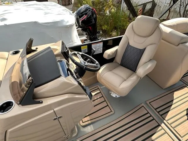 Slide: The Image of 2024 Starcraft SLS-3 boat interior with captain's chair and steering console. - 3