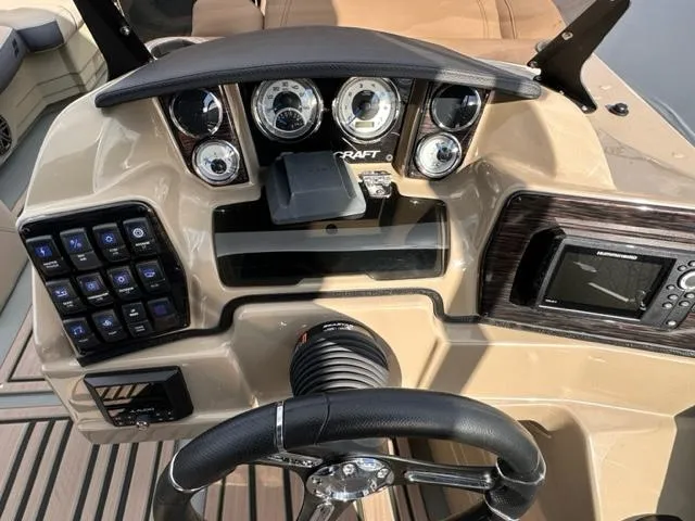 Slide: The Image of 2024 Starcraft SLS-3 boat dashboard with steering wheel, gauges, and control panel. - 4
