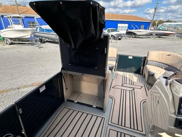 Slide: The Image of 2024 Starcraft SLS-3 boat interior with open storage compartment and seating area. - 5