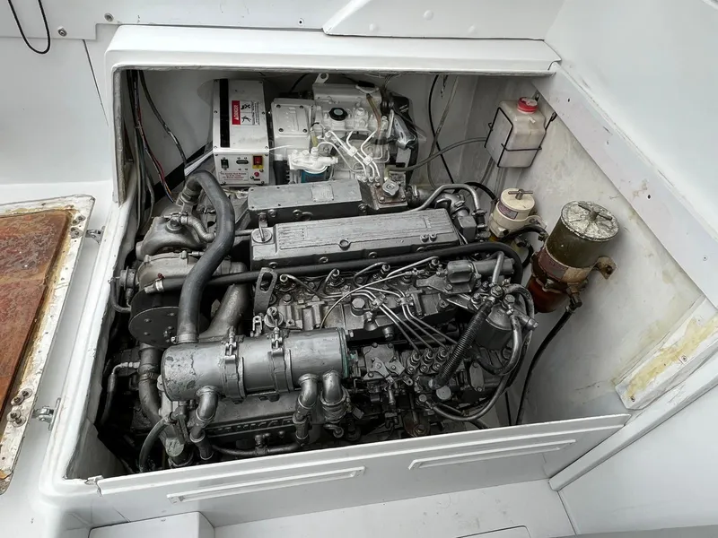 Slide: The Image of 1973 Bertram 31 engine compartment with visible mechanical components and wiring. - 10