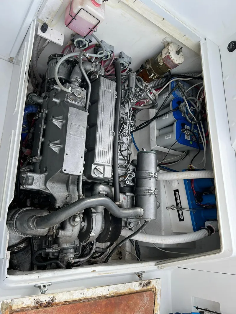 Slide: The Image of Engine compartment of a 1973 Bertram 31 boat, showcasing detailed mechanical components. - 11