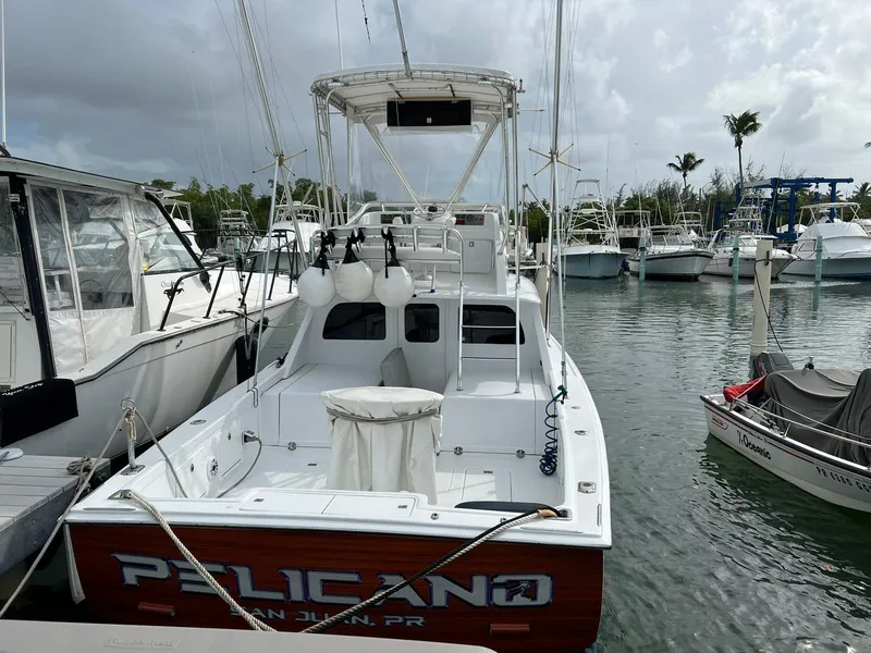 Slide: The Image of 1973 Bertram 31 boat named "Pelicano" docked in a marina, San Juan, Puerto Rico. - 12