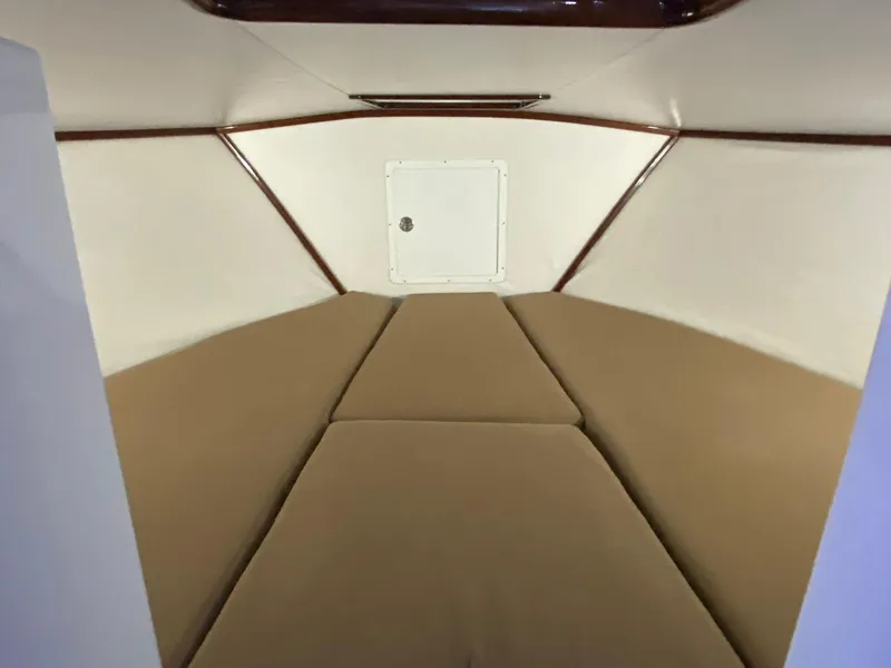Slide: The Image of Interior cabin of a 1973 Bertram 31 boat with beige cushions. - 8