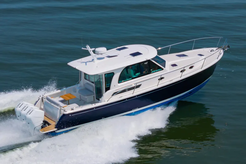 The Image of 2025 Back Cove 39O yacht cruising on open water, showcasing sleek design and powerful engines. - 0