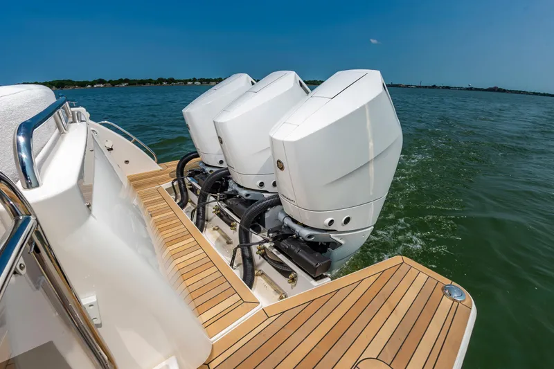 Slide: The Image of 2025 Back Cove 39O boat with triple outboard engines on water. - 10