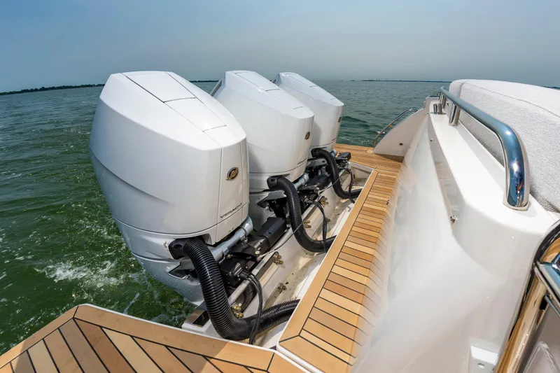 Slide: The Image of 2025 Back Cove 39O boat with powerful outboard engines on open water. - 11
