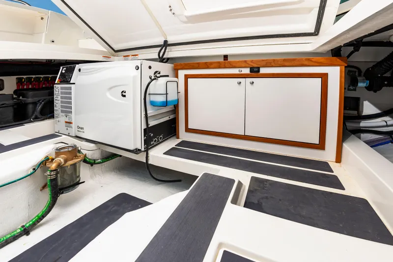 Slide: The Image of Engine compartment of 2025 Back Cove 39O boat with Onan generator and storage cabinet. - 13