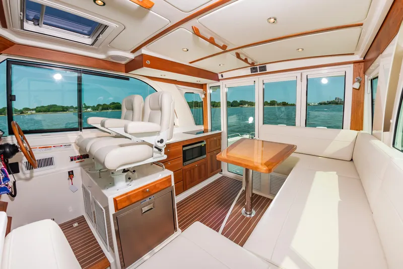 Slide: The Image of Luxurious interior of 2025 Back Cove 39O yacht with plush seating and elegant wood finishes. - 15