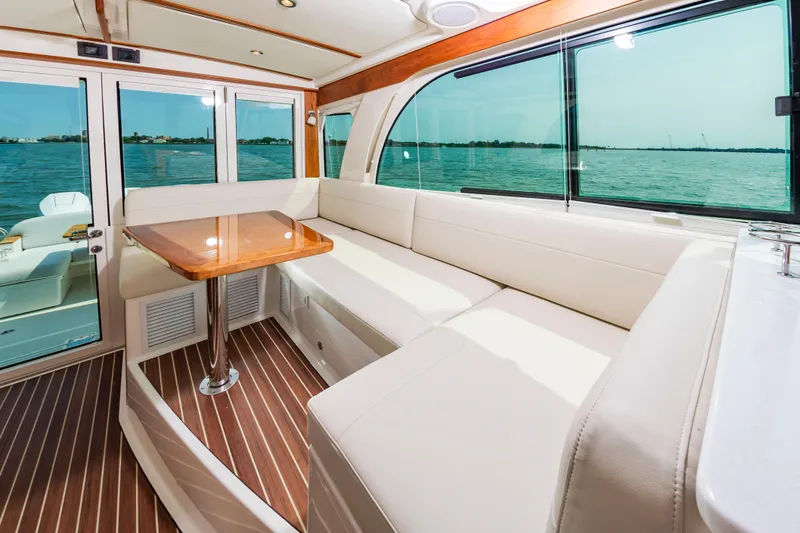 Slide: The Image of Luxurious interior of 2025 Back Cove 39O yacht with elegant seating and scenic water view. - 16