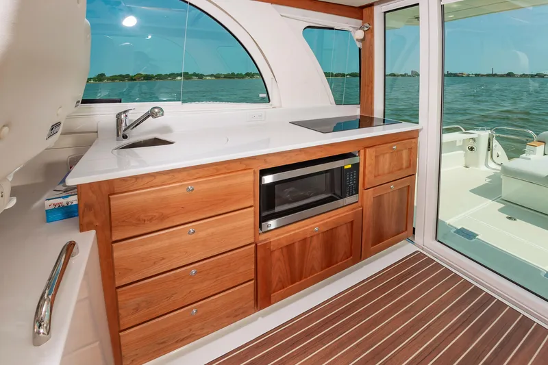 Slide: The Image of Luxurious 2025 Back Cove 39O yacht interior with modern kitchen and scenic water view. - 17