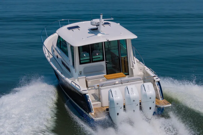 Slide: The Image of 2025 Back Cove 39O boat cruising on open water, rear view. - 2