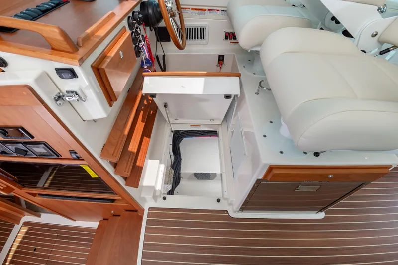 Slide: The Image of 2025 Back Cove 39O interior with open storage, wooden accents, and plush seating. - 21