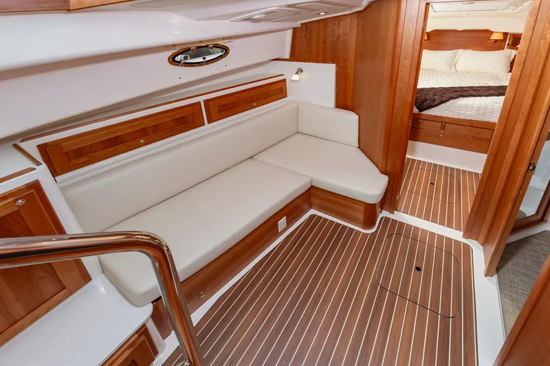 Slide: The Image of Luxurious interior of 2025 Back Cove 39O yacht with wood accents and cozy seating. - 24