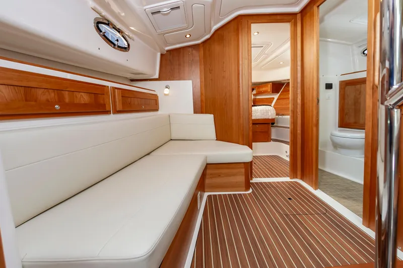 Slide: The Image of Luxurious interior of 2025 Back Cove 39O yacht with wood accents and white seating. - 26