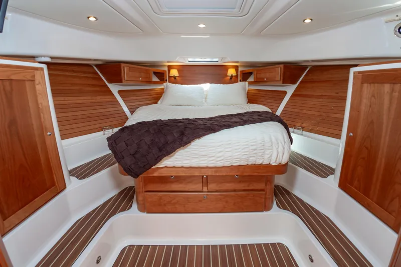 Slide: The Image of Luxurious cabin interior of 2025 Back Cove 39O yacht with wood accents and cozy bedding. - 27