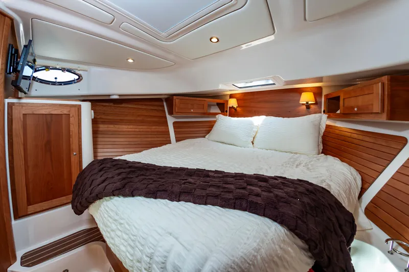 Slide: The Image of Luxurious cabin interior of 2025 Back Cove 39O yacht with cozy bedding and wooden accents. - 28