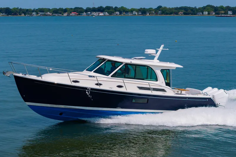 Slide: The Image of 2025 Back Cove 39O cruising on a calm blue sea. - 4