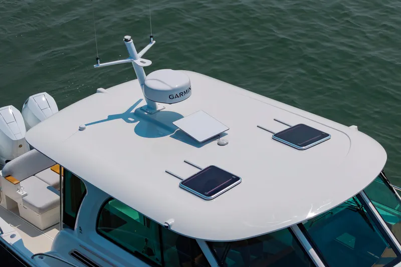 Slide: The Image of 2025 Back Cove 39O boat roof with radar and hatches on water. - 6