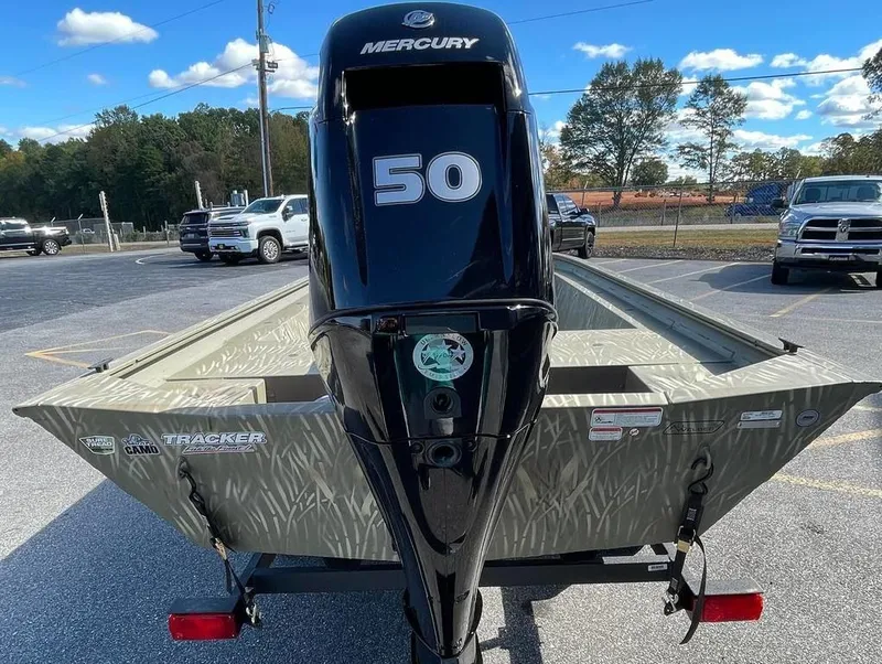 Slide: The Image of 2024 Tracker GRIZZLY® 1754 Jon boat with Mercury 50 HP engine in parking lot. - 10