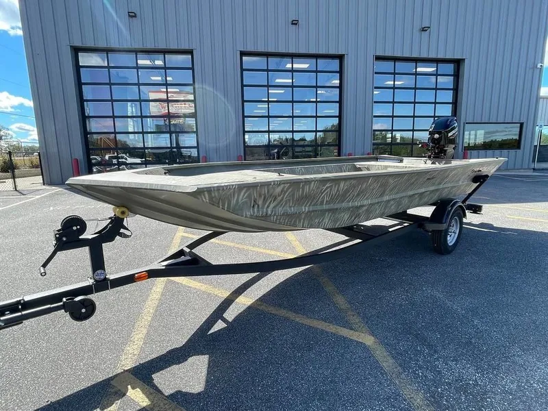 Slide: The Image of 2024 Tracker GRIZZLY® 1754 Jon boat on trailer outside a building. - 12