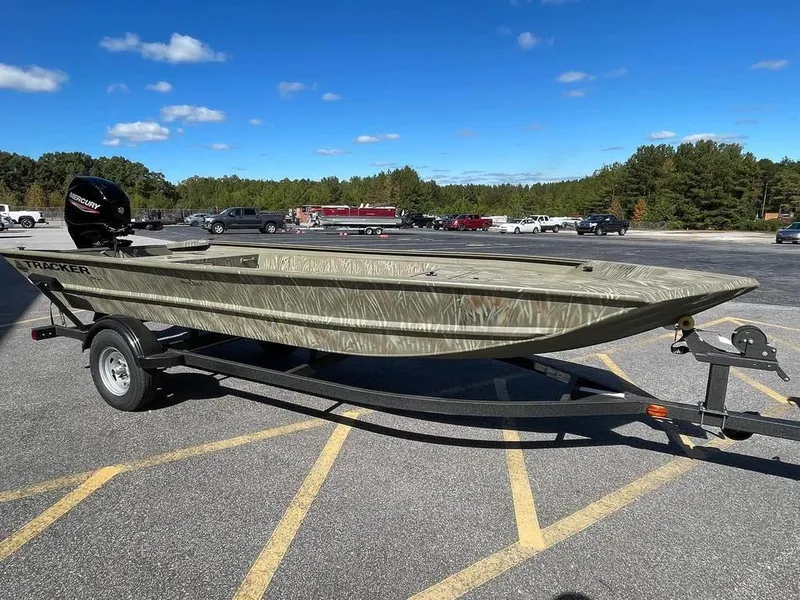 Slide: The Image of 2024 Tracker GRIZZLY® 1754 Jon boat on a trailer in a parking lot. - 8