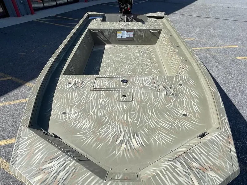 Slide: The Image of 2024 Tracker GRIZZLY® 1754 Jon boat with camo pattern, spacious interior, and durable design. - 9