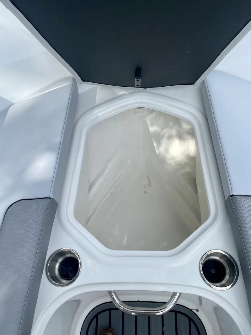 Slide: The Image of 2024 Bayliner VR4 boat interior storage compartment with cup holders. - 13