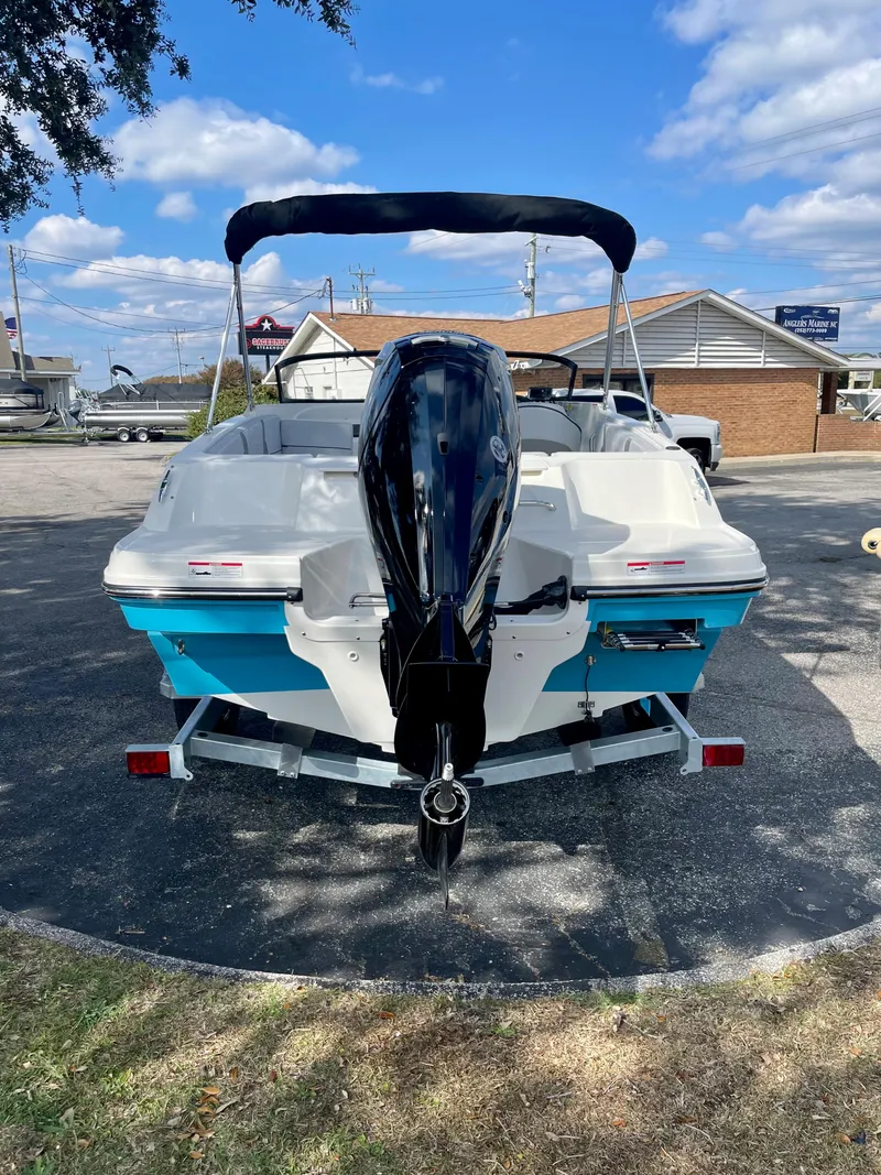 Slide: The Image of 2024 Bayliner VR4 boat with outboard motor, parked on a trailer. - 2