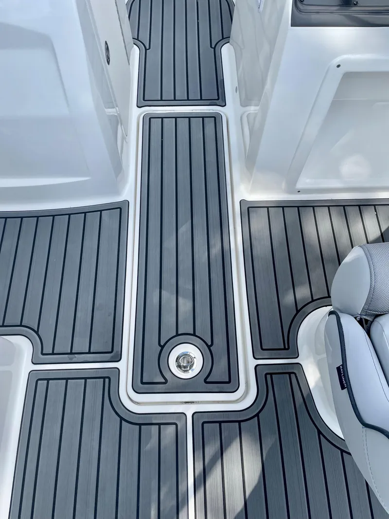 Slide: The Image of 2024 Bayliner VR4 boat deck with gray and white non-slip flooring. - 10