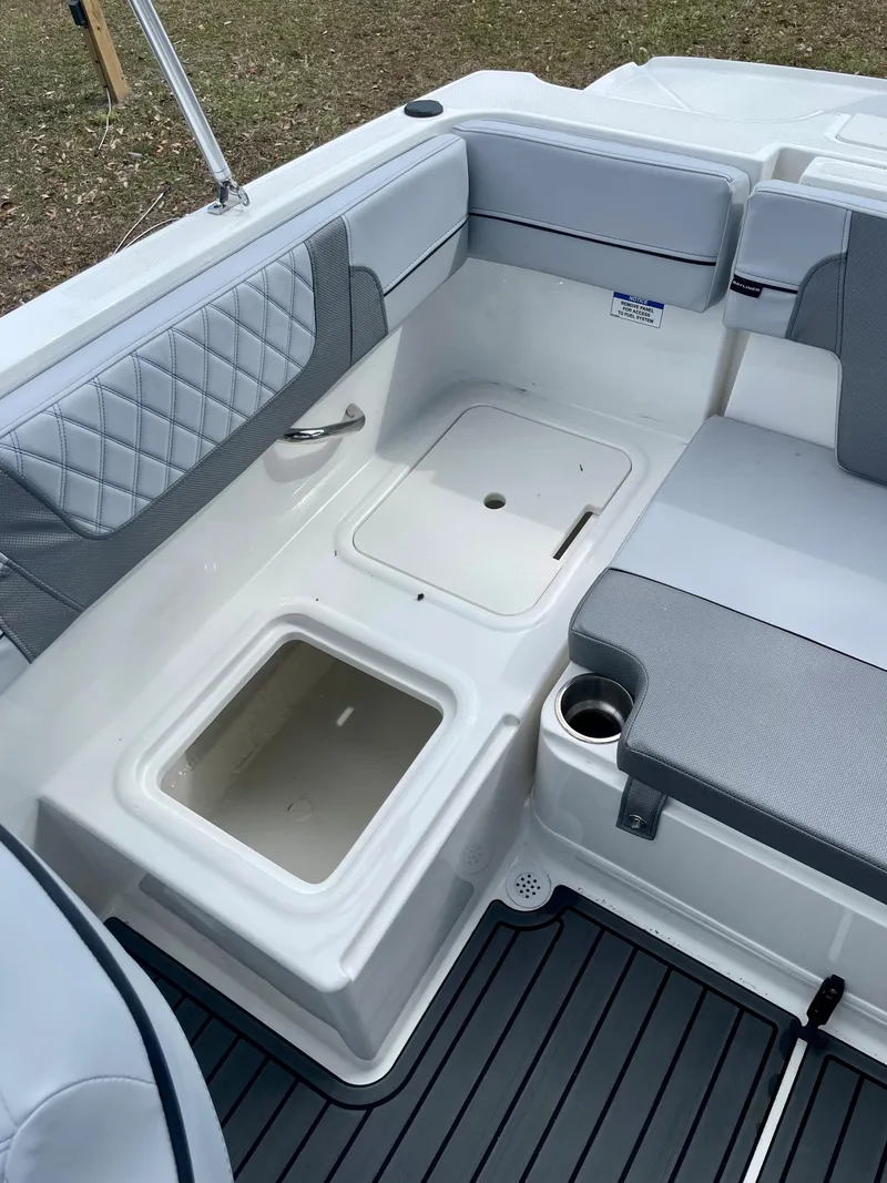 Slide: The Image of 2024 Bayliner VR4 boat interior with storage compartments and cushioned seating. - 12