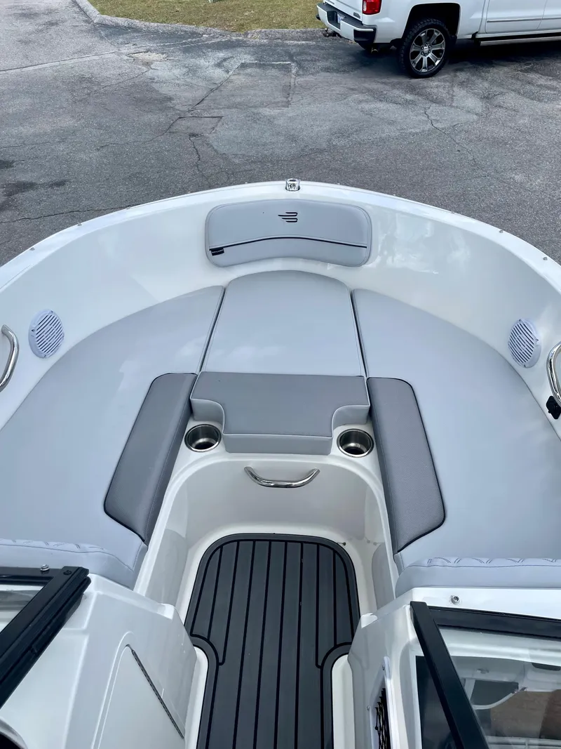 Slide: The Image of 2024 Bayliner VR4 boat interior with cushioned seating and cup holders. - 17