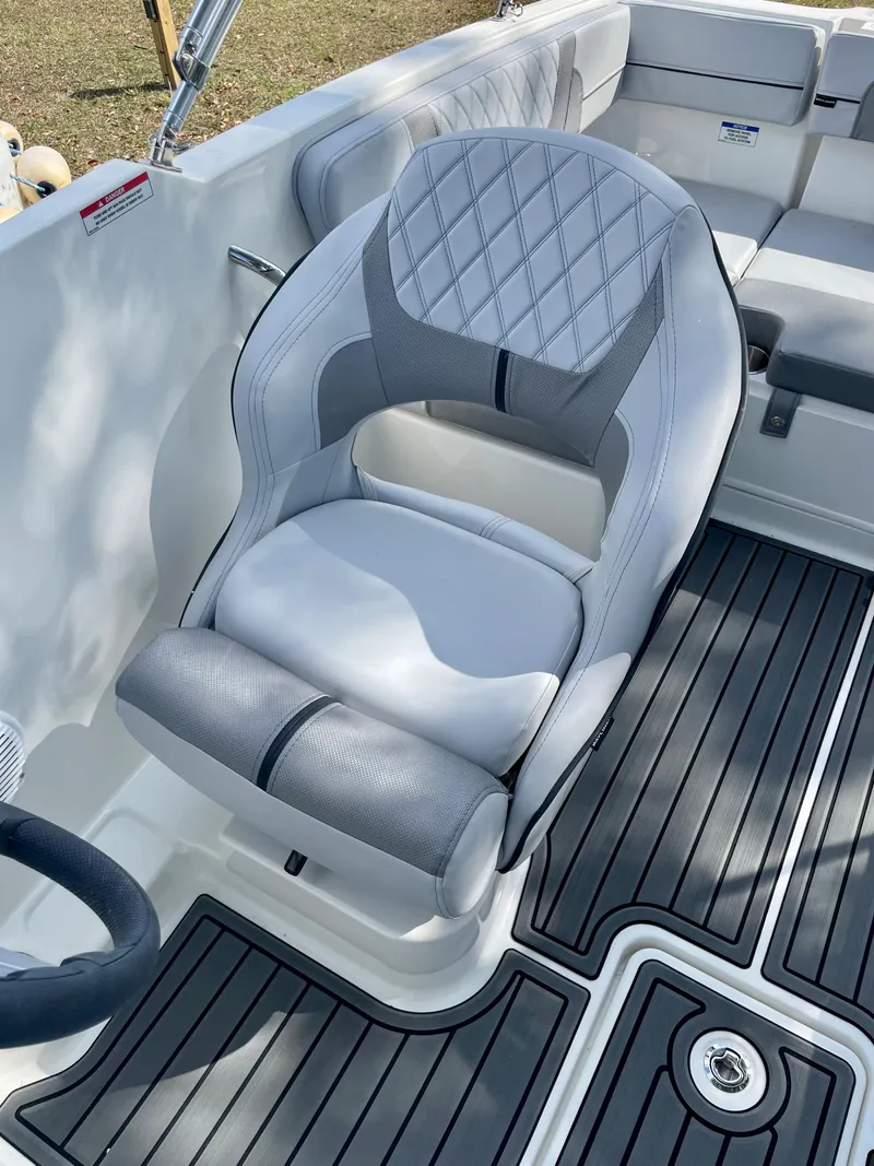 Slide: The Image of 2024 Bayliner VR4 boat interior with cushioned seating and non-slip flooring. - 5