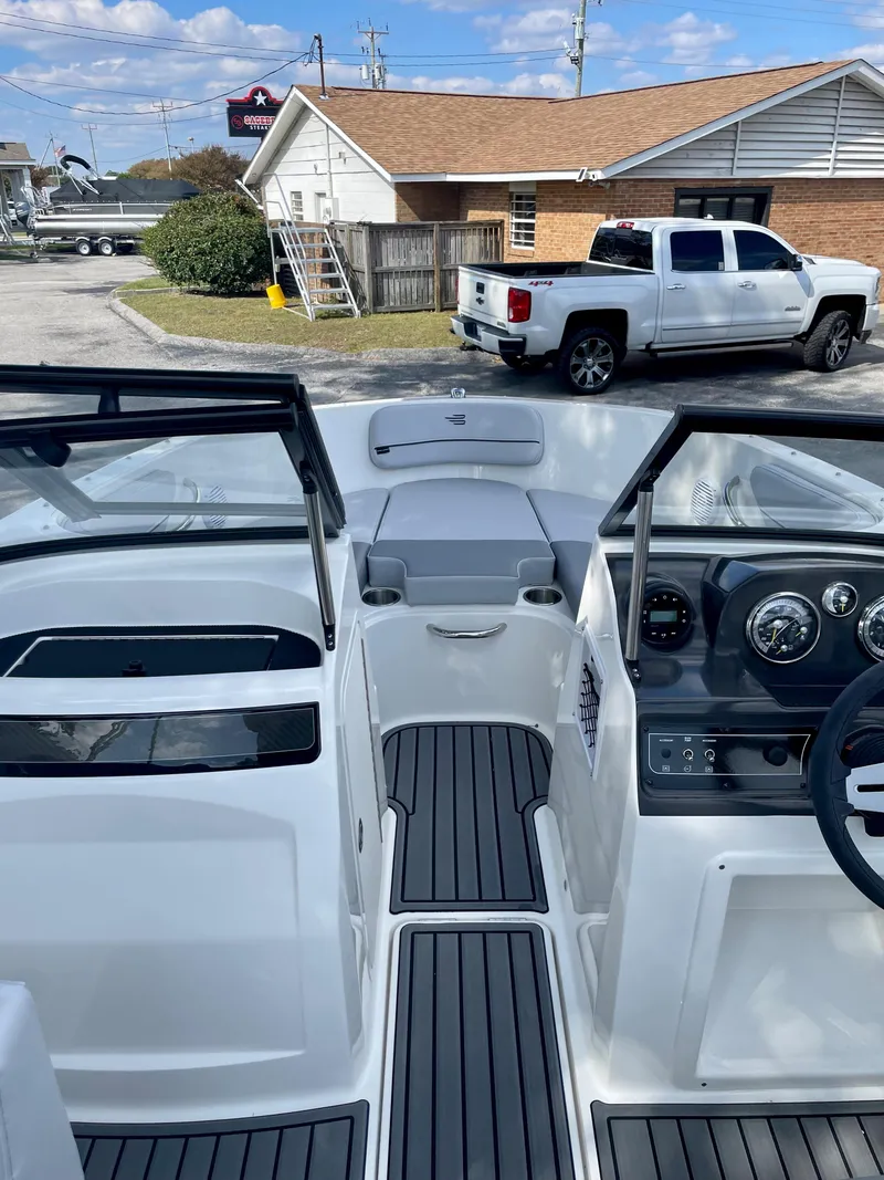 Slide: The Image of 2024 Bayliner VR4 boat interior with modern dashboard and seating. - 7