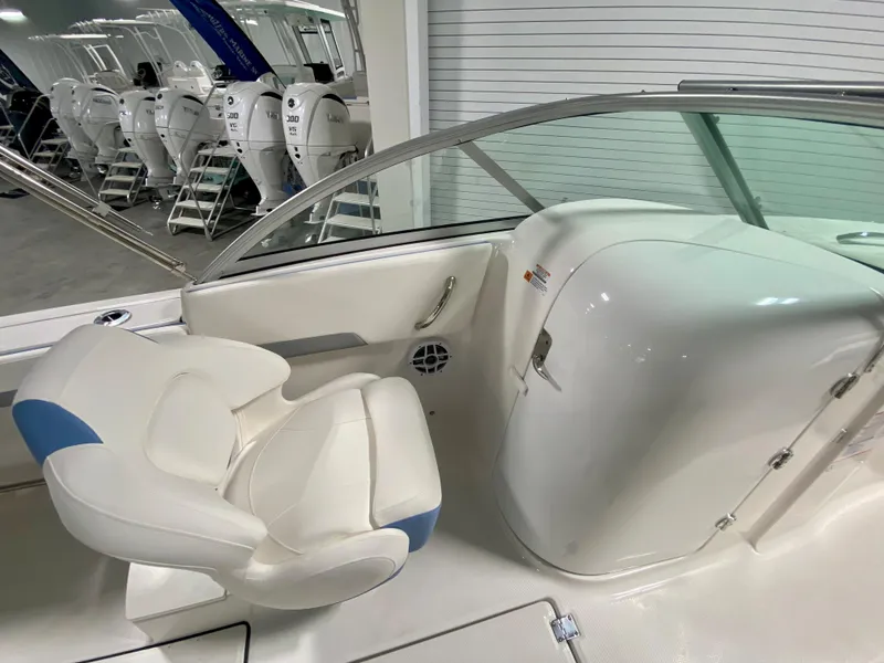 Slide: The Image of 2024 Robalo R207 Dual Console boat interior with white and blue seating. - 15