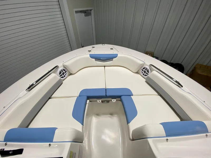 Slide: The Image of 2024 Robalo R207 Dual Console boat interior with white and blue seating. - 19