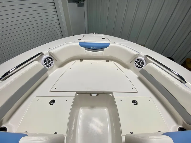 Slide: The Image of 2024 Robalo R207 Dual Console boat bow seating area with storage compartments. - 21