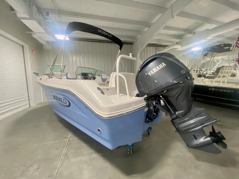 Slide: The Image of 2024 Robalo R207 Dual Console boat with Yamaha outboard motor in showroom. - 3