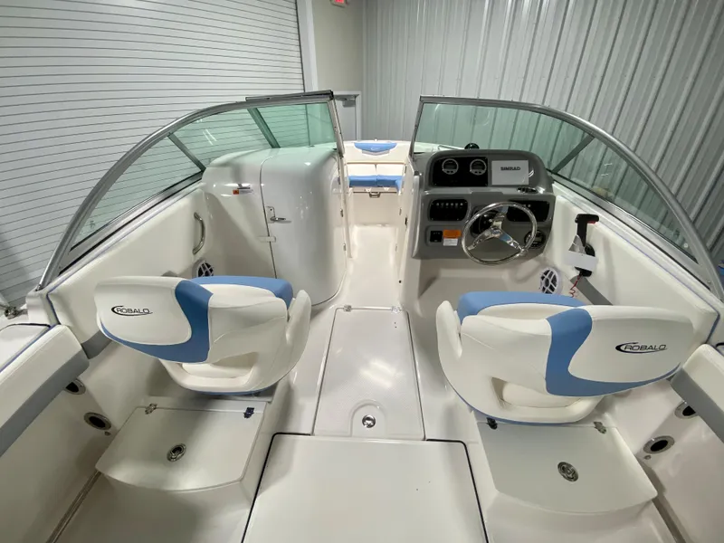 Slide: The Image of 2024 Robalo R207 Dual Console boat interior with white and blue seating. - 6