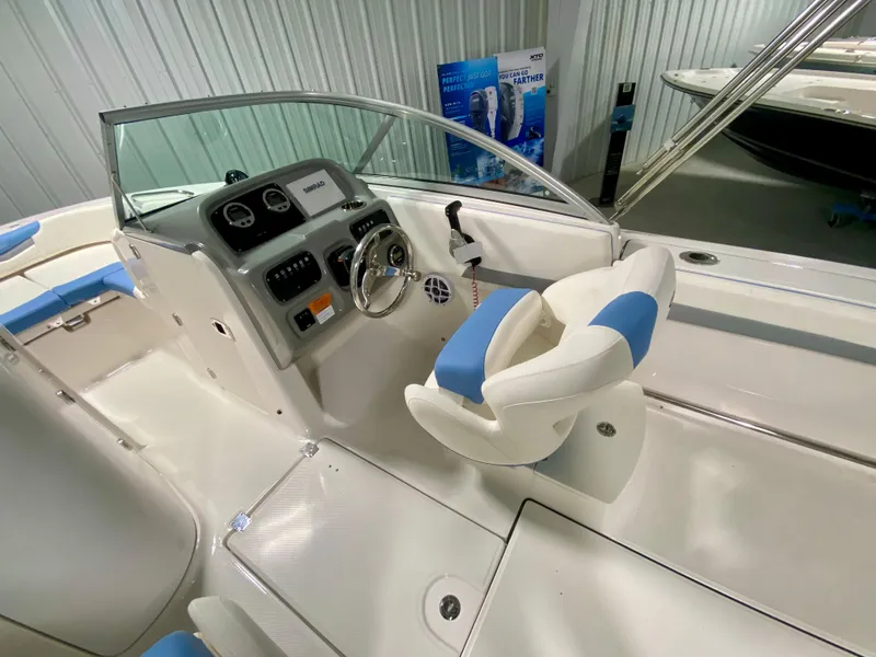 Slide: The Image of 2024 Robalo R207 Dual Console boat interior with steering wheel and seating. - 9