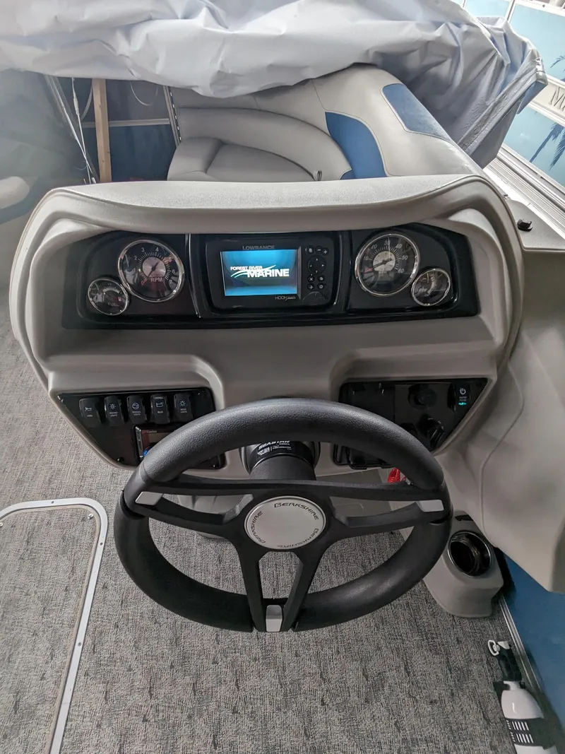Slide: The Image of 2024 Berkshire 20RFX LE boat dashboard with steering wheel and control panel. - 3