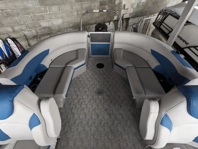 Slide: The Image of 2024 Berkshire 20RFX LE pontoon boat interior with gray and blue seating. - 8